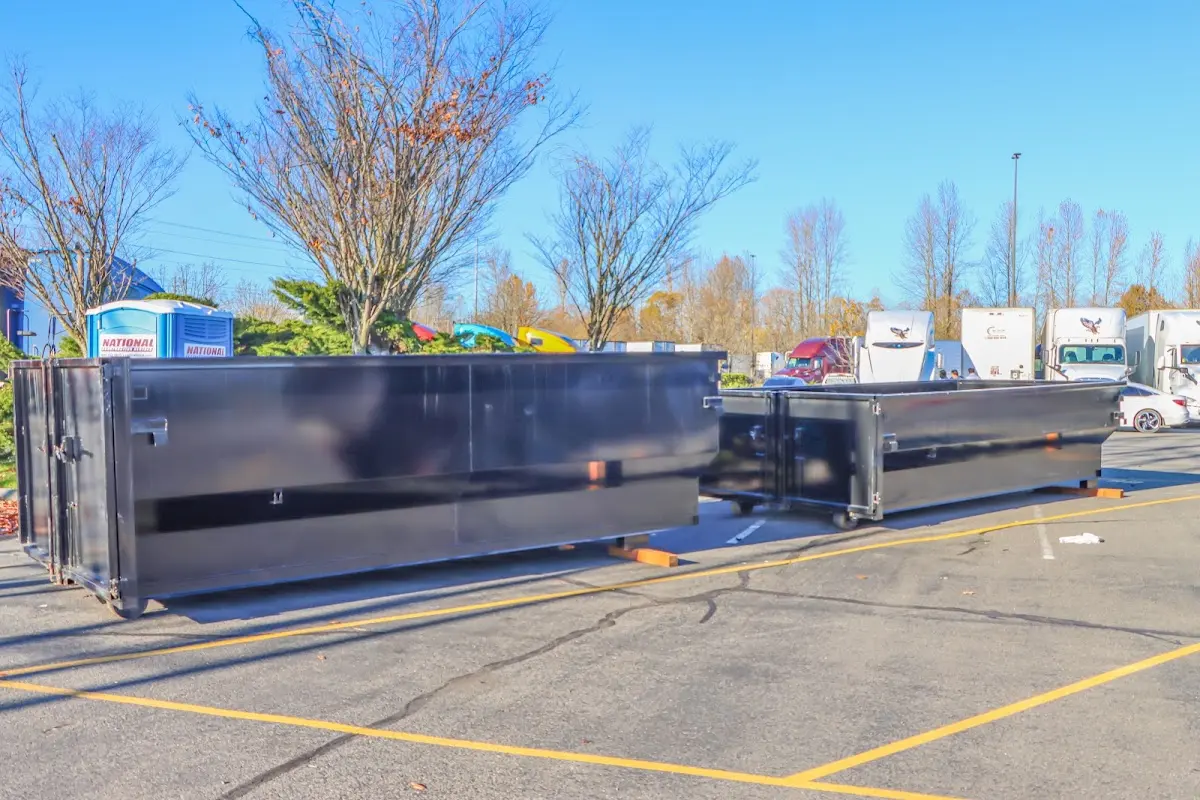 Professional dumpster rental service with roll-off container on residential driveway in Mequon